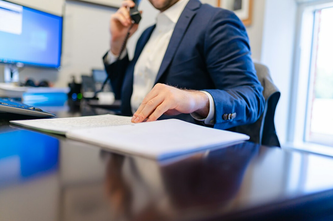 confident negotiator at desk